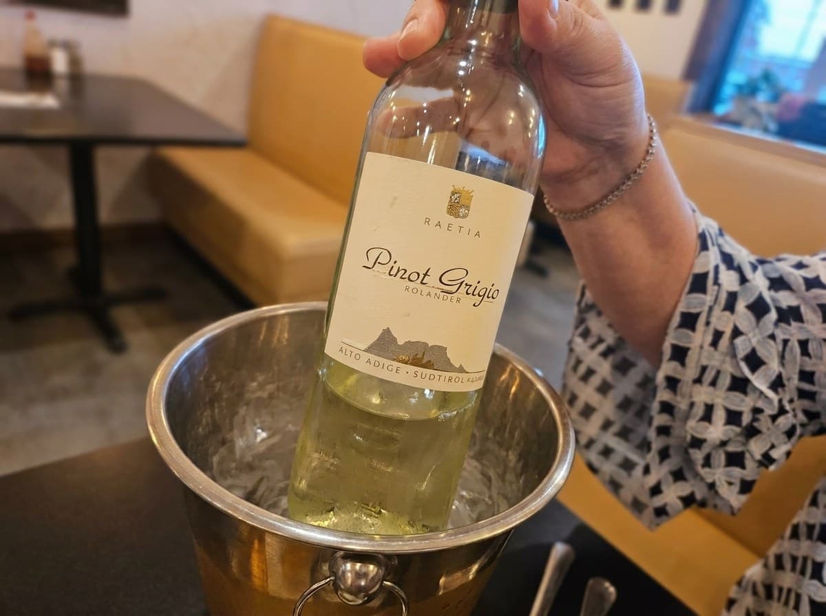 A bottle of Pinot Grigio lifted from an ice bucket